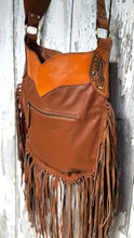 Load image into Gallery viewer, Back view of tan leather fringe crossbody bag with rear zip pocket and long fringe.