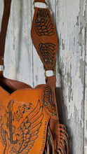 Load image into Gallery viewer, Genuine leather shoulder strap close up with carved wing detail on guitar fringe handbag.