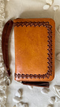 Load image into Gallery viewer, Back view of tan genuine leather boho wallet with woven leather edging and wristlet strap