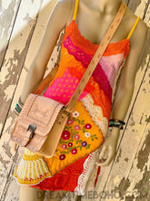 Load image into Gallery viewer, Natural tan hand tooled leather saddle crossbody bag with buckle flap closure styled with bright boho patchwork dress.