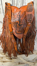 Load image into Gallery viewer, Winged guitar artisan leather handbag close up showing musical note artwork and fringe detail.