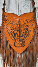 Load image into Gallery viewer, Close up front of winged guitar genuine leather handbag with long fringe and artisan detail.