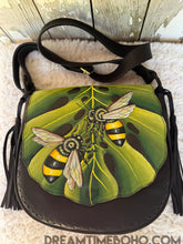 Load image into Gallery viewer, Close-up of hand-painted bees on monstera leaf artwork on Bee Story leather crossbody bag