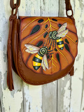 Load image into Gallery viewer, Bee Story hand tooled leather boho bag featuring hand painted bee and monstera leaf design
