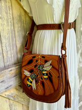 Load image into Gallery viewer, Front view of Bee Story hand painted leather crossbody bag with bee and leaf design

