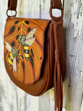 Load image into Gallery viewer, Side view of Bee Story leather crossbody bag showing removable tassel and hand stitched detailing