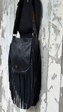 Load image into Gallery viewer, Black genuine leather crossbody bag with adjustable strap, magnetic closure and fringe detailing