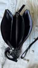 Load image into Gallery viewer, Interior of black 3-way leather crossbody clutch showing three large zip compartments and six card slots.