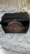Load image into Gallery viewer, Close up of black tooled leather wallet with intricate mandala artwork and turquoise gemstone detail