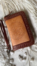 Load image into Gallery viewer, Boheme hand tooled leather wallet in warm tan and brown with mandala design, woven leather edging and removable wrist strap by Dreamtime Boho 