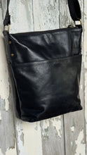 Load image into Gallery viewer, Back angled view of the Boho Harmony black genuine leather crossbody bag showing the magnetic rear pouch pocket and soft leather finish.
