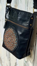 Load image into Gallery viewer, Close-up angled view of the handcrafted mandala artwork with turquoise accents on the Boho Harmony black genuine leather crossbody bag.