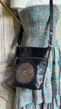 Load image into Gallery viewer, Boho Harmony Mandala Leather Crossbody Bag in black genuine leather worn with a bohemian dress, featuring turquoise mandala detailing. Designed in Australia by Dreamtime Boho.