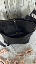 Load image into Gallery viewer, Open view of the Boho Harmony black genuine leather crossbody bag showing the spacious interior with zip pocket and pouch pockets.