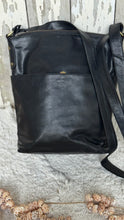 Load image into Gallery viewer, Rear view of the Boho Harmony black leather crossbody bag showing the magnetic slip pocket and adjustable leather strap. Designed in Australia by Dreamtime Boho.