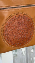 Load image into Gallery viewer, Close-up of the intricate hand-tooled mandala leather artwork on the Boho Harmony Crossbody Bag in tan genuine leather. Designed in Australia by Dreamtime Boho.