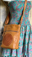 Load image into Gallery viewer, Boho Harmony Mandala Leather Crossbody Bag worn with a bohemian dress, handcrafted from genuine leather with an adjustable shoulder strap. Designed in Australia by Dreamtime Boho.