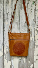 Load image into Gallery viewer, Boho Harmony Mandala Leather Crossbody Bag in tan genuine leather with hand-tooled mandala detail and adjustable crossbody strap. Designed in Australia by Dreamtime Boho.