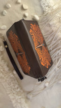 Load image into Gallery viewer, Top view of brown handcrafted leather dragonfly wallet showing tooled design and zip-around closure
