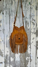 Load image into Gallery viewer, Tan hand tooled leather fringe crossbody bag with floral tooling, gemstone detail and adjustable shoulder strap.