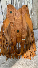 Load image into Gallery viewer, Front view of the Desert Bloom genuine leather crossbody bag showing the adjustable hand tooled crossbody strap and long fringe.