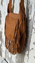 Load image into Gallery viewer, Side view of the Desert Willow genuine tan leather crossbody bag showing flowing leather fringe and soft leather construction.