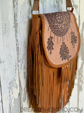 Load image into Gallery viewer, Dreamcatcher leather fringe crossbody bag side view showing hand-tooled detailing and flowing fringe
