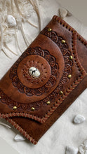 Load image into Gallery viewer, Close up of antique brown genuine leather wallet with hand tooled mandala design, brass studs and natural stone centrepiece by Dreamtime Boho.