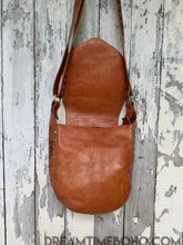 Load image into Gallery viewer, Front view under flap of Floral Spirit genuine leather boho crossbody bag in tan showing smooth leather finish.
