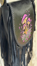 Load image into Gallery viewer, Close-up of genuine black leather fringe and decorative braided edging on the Mushroom Magic handcrafted bohemian handbag.