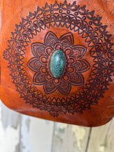 Load image into Gallery viewer, Close up of hand tooled mandala design with turquoise stone on soft leather boho crossbody bag