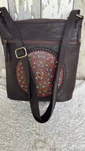 Load image into Gallery viewer, Handcrafted chocolate leather mandala shoulder bag with adjustable crossbody strap, turquoise detailing and intricate artisan leather tooling.