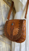 Load image into Gallery viewer, Handcrafted vintage leather crossbody bag showing tooled detailing and adjustable shoulder strap