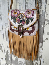 Load image into Gallery viewer, Hand tooled hibiscus leather fringe crossbody bag with distressed off white leather and double fringe boho design