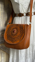Load image into Gallery viewer, Mandala leather crossbody bag worn with a white boho dress, featuring genuine leather, gemstone detail and adjustable strap. Designed in Australia by Dreamtime Boho.