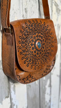 Load image into Gallery viewer, Side angle of Mandala Vintage Crossbody Leather Boho Bag showing hand tooled leather flap and adjustable strap