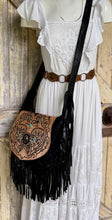 Load image into Gallery viewer, Model wearing the Midnight Oasis black genuine leather fringe crossbody bag with hand tooled detailing, turquoise accents and adjustable strap.