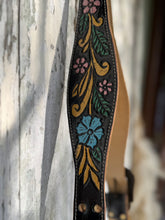 Load image into Gallery viewer, Close up of hand tooled and hand painted leather strap on Midnight Starfall boho crossbody bag with floral design and antique brass hardware
