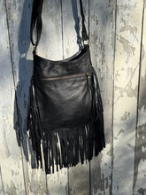 Load image into Gallery viewer, Back view of black genuine leather fringe boho bag with rear zip pocket.
