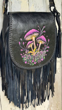 Load image into Gallery viewer, Handcrafted leather fringe handbag featuring intricate hand-tooled mushrooms in purple and pink with botanical detailing and flowing black fringe.