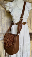 Load image into Gallery viewer, Myla brown hand tooled leather crossbody boho bag worn by model showing adjustable leather strap