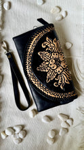 Load image into Gallery viewer, Black boho leather wallet clutch with hand tooled floral front flap and removable wristlet strap