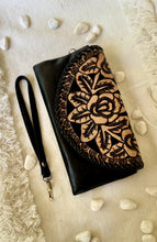 Load image into Gallery viewer, Black boho leather wallet clutch with contrasting hand tooled floral design and wristlet strap