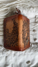 Load image into Gallery viewer, Top view of antique brown hand tooled leather wallet showing detailed artisan tooling on both sides