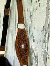 Load image into Gallery viewer, Hand-tooled leather strap detail on Sahara Moon black and tan boho crossbody bag with antique brass hardware