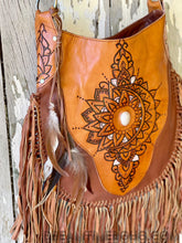 Load image into Gallery viewer, Close view of Sahara tan handcrafted leather fringe bag with mandala artwork, white feature stone and feather detailing