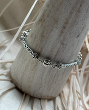 Load image into Gallery viewer, Sterling silver boho bracelet worn on display, featuring handcrafted braided silver links and bead details