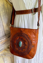 Load image into Gallery viewer, Soft genuine leather mandala crossbody bag with hand carved boho pattern and turquoise stone, styled with white dress