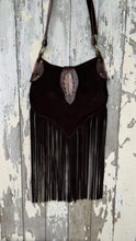 Load image into Gallery viewer, Rear view of dark chocolate suede leather fringe crossbody bag with feather detail