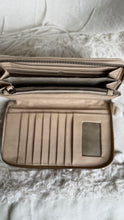 Load image into Gallery viewer, Interior of tan hand tooled leather wallet showing card slots, compartments and zip pocket